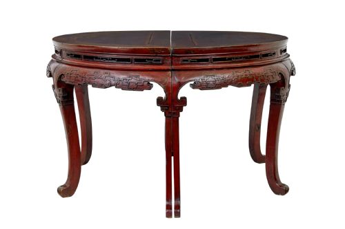 fig 1. A pair of 19th-century Chinese red lacquer demi-lune tables joined together to form a circular table with carved key-fret aprons and cabriole legs.