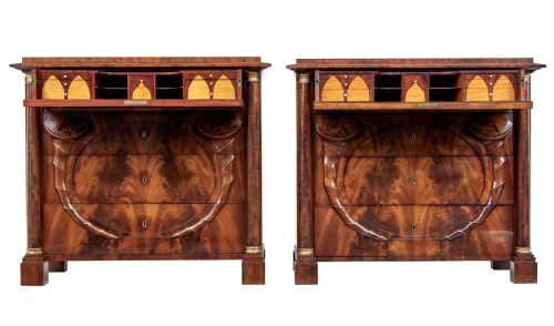 fig 1. A matching pair of early nineteenth-century mahogany Biedermeier commodes featuring carved cornucopia motifs and side columns.