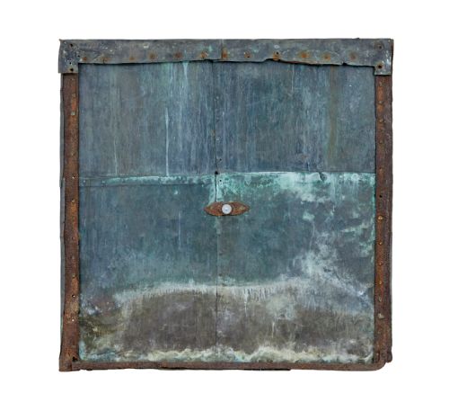 fig 1. A square 18th-century Swedish copper turret clock face featuring a green verdigris patina, central sunburst motif, Roman numerals, and a single hand shaped like a pointer.