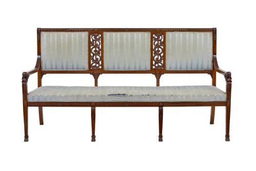 fig 1. An early twentieth-century seven-piece Empire Revival walnut salon suite comprising a bench, two armchairs, and four side chairs with carved serpent back splats.