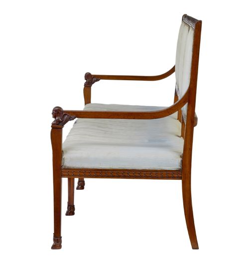 fig 2. An early twentieth-century seven-piece Empire Revival walnut salon suite comprising a bench, two armchairs, and four side chairs with carved serpent back splats.