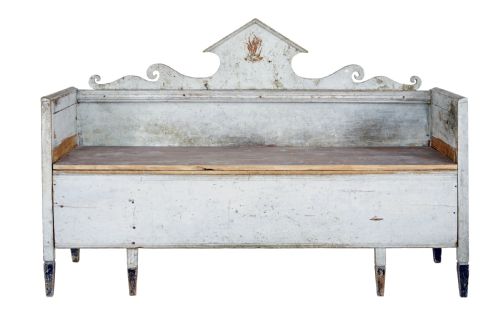fig 1. An early 19th-century Swedish Gustavian bench in distressed grey paint featuring a pedimented backrest and tapered legs.