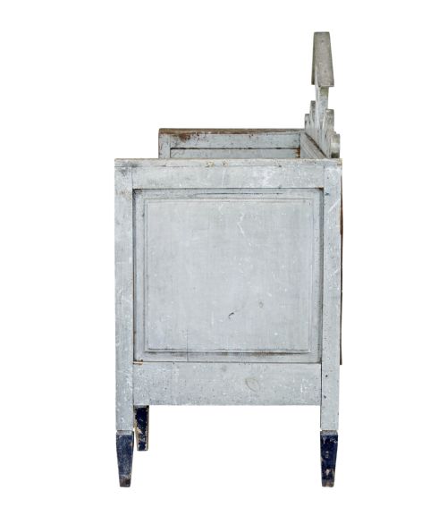 fig 2. An early 19th-century Swedish Gustavian bench in distressed grey paint featuring a pedimented backrest and tapered legs.