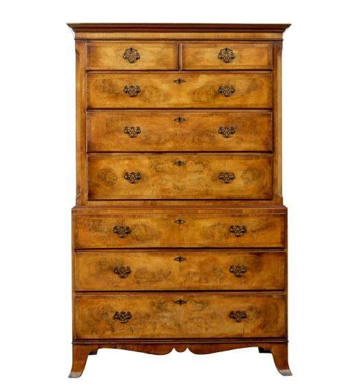 fig 1. A two-section Late Georgian walnut chest on chest featuring figured timber veneers, brass drop handles, and bracket feet.