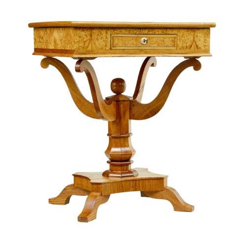 fig 1. A 19th-century Scandinavian occasional table made of burr birch and elm with a single drawer, S-curved supports, a turned central pedestal, and a four-footed base.