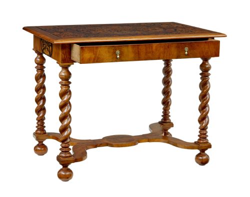 fig 1. A 19th-century rectangular walnut table featuring intricate floral marquetry inlay on the top surface, a single drawer, four spiral twist legs, and a shaped stretcher.