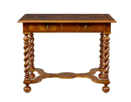fig 2. A 19th-century rectangular walnut table featuring intricate floral marquetry inlay on the top surface, a single drawer, four spiral twist legs, and a shaped stretcher.