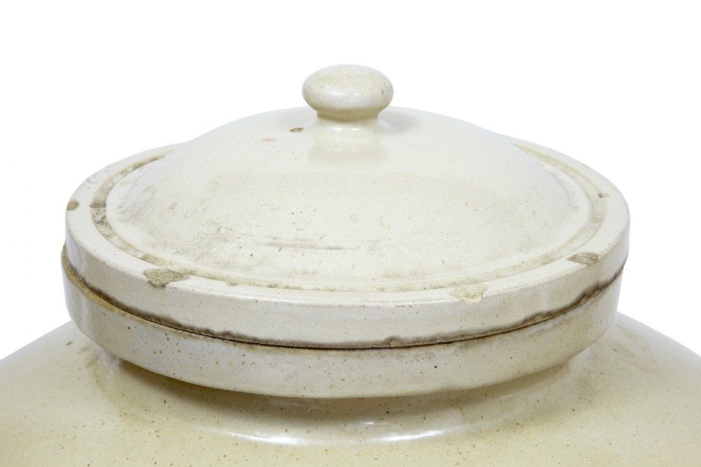 A pair of large cream glazed stoneware alcohol jars featuring hooded lug handles, lower spigot holes, and fitted lids. View III