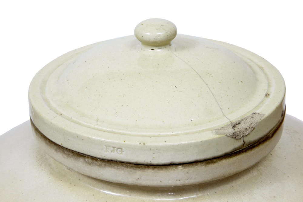 A pair of large cream glazed stoneware alcohol jars featuring hooded lug handles, lower spigot holes, and fitted lids. View IV