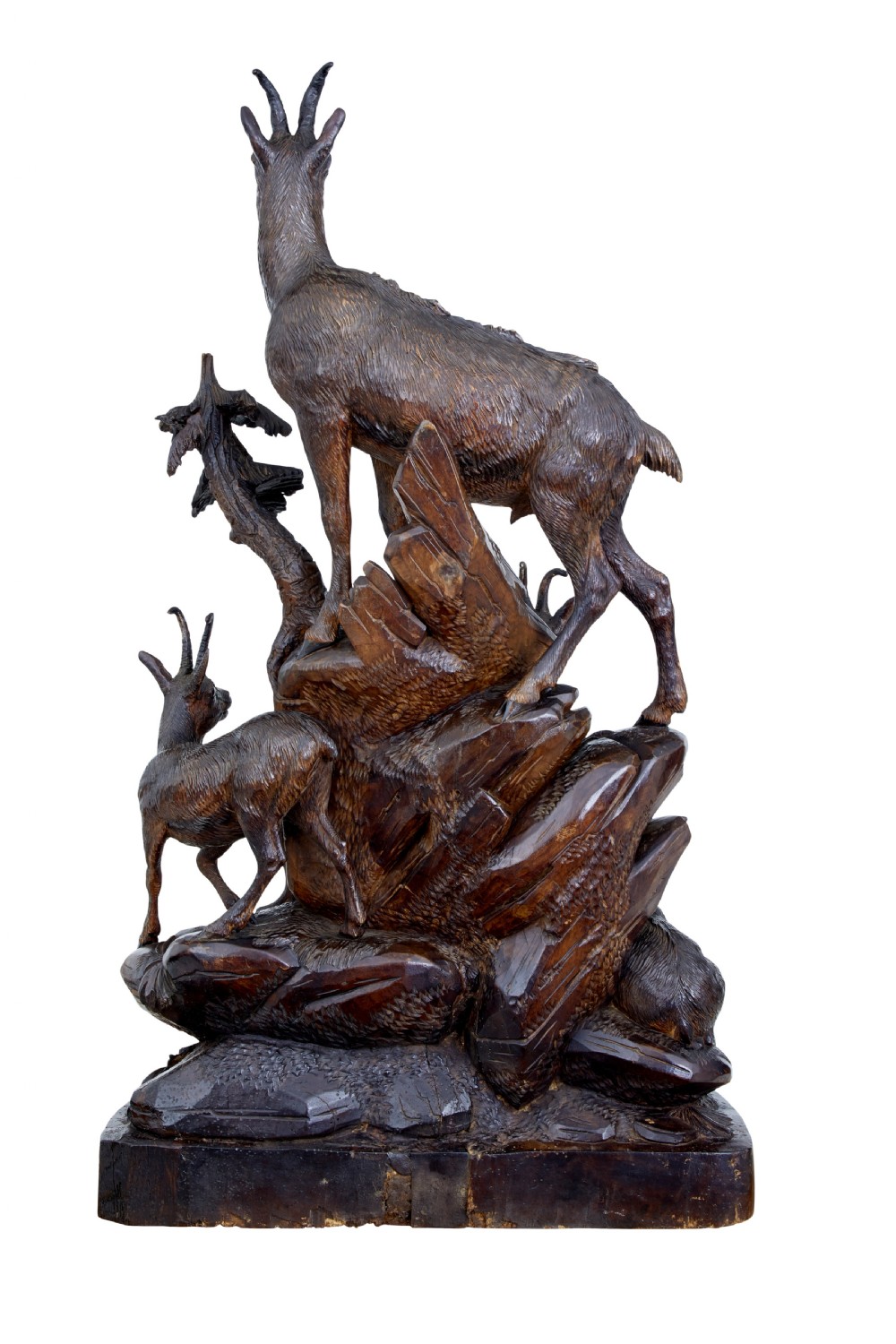 A detailed 19th-century hand-carved linden wood sculpture featuring an alpine ibex standing on a rocky outcrop surrounded by smaller goats. View IV