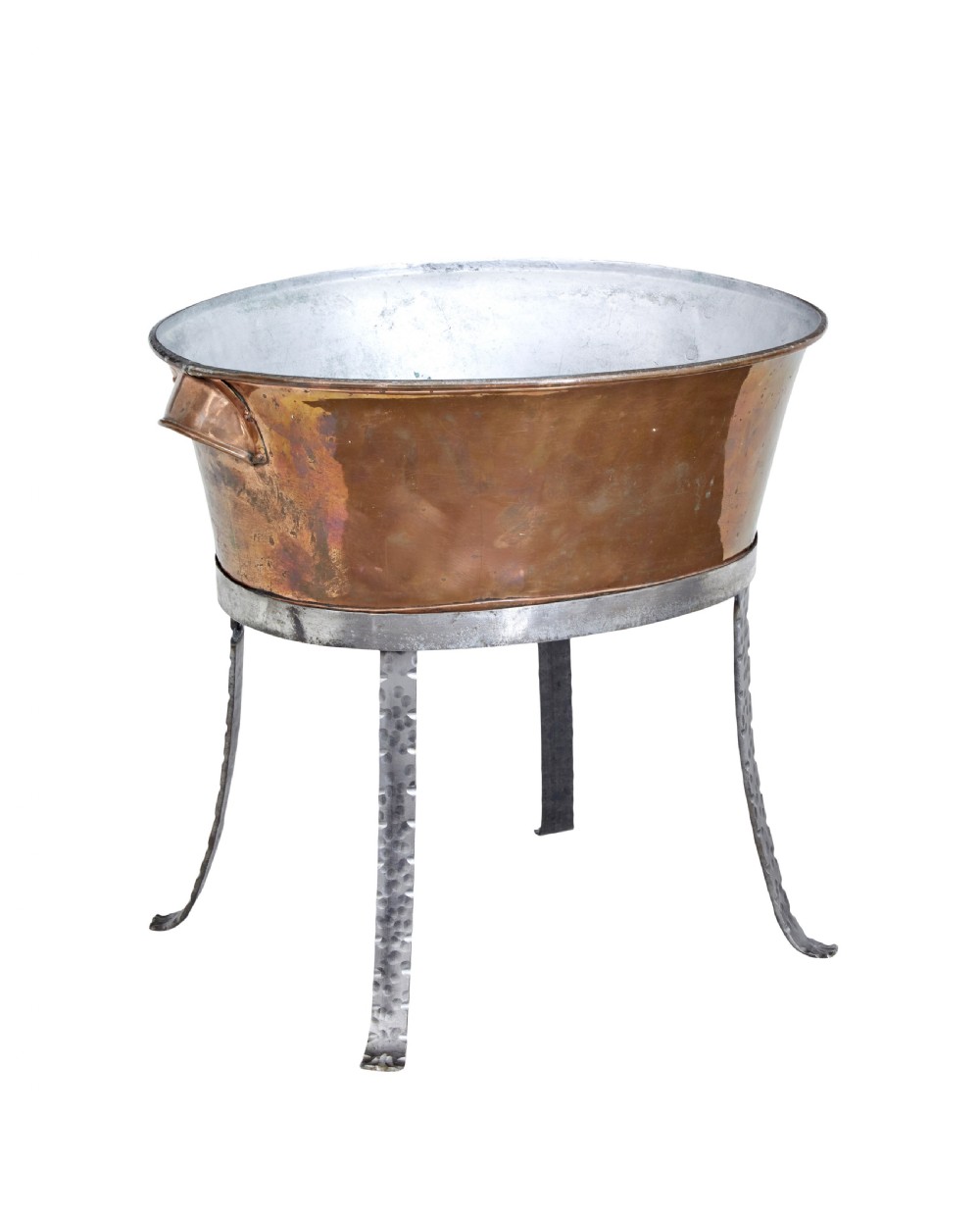 An oval copper basin with a silver-coloured lining and side handles, elevated on a four-legged hammered wrought iron stand.