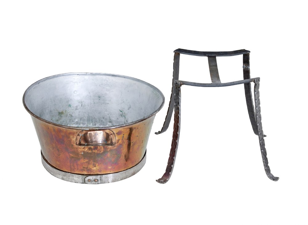 An oval copper basin with a silver-coloured lining and side handles, elevated on a four-legged hammered wrought iron stand. View IV