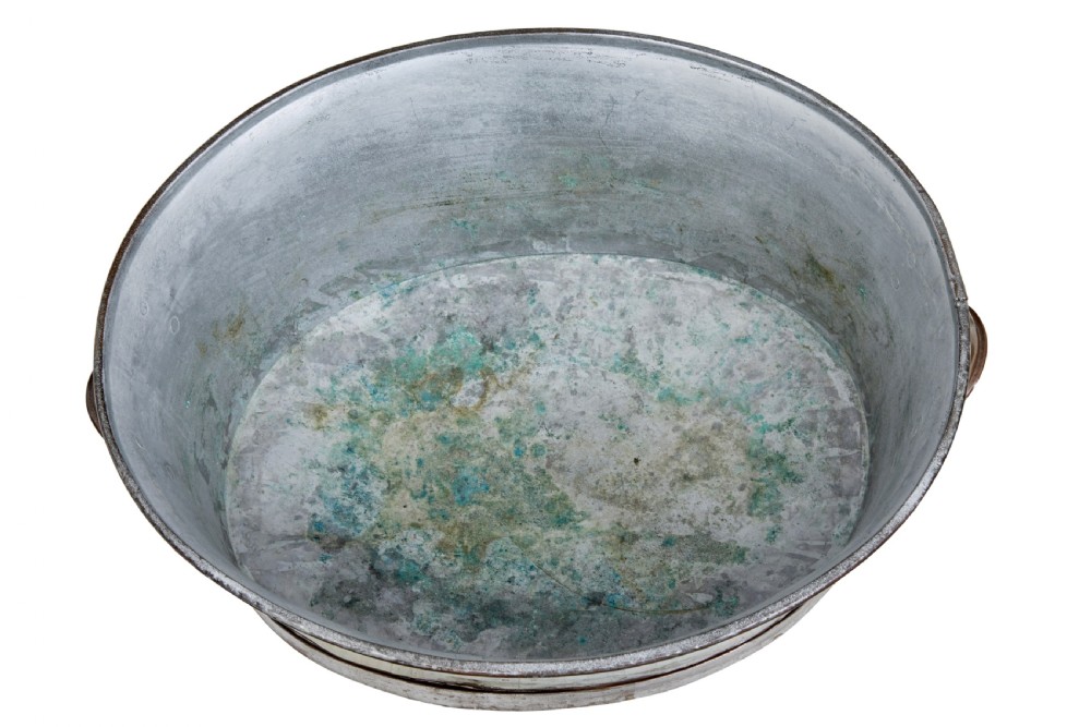 An oval copper basin with a silver-coloured lining and side handles, elevated on a four-legged hammered wrought iron stand. View V