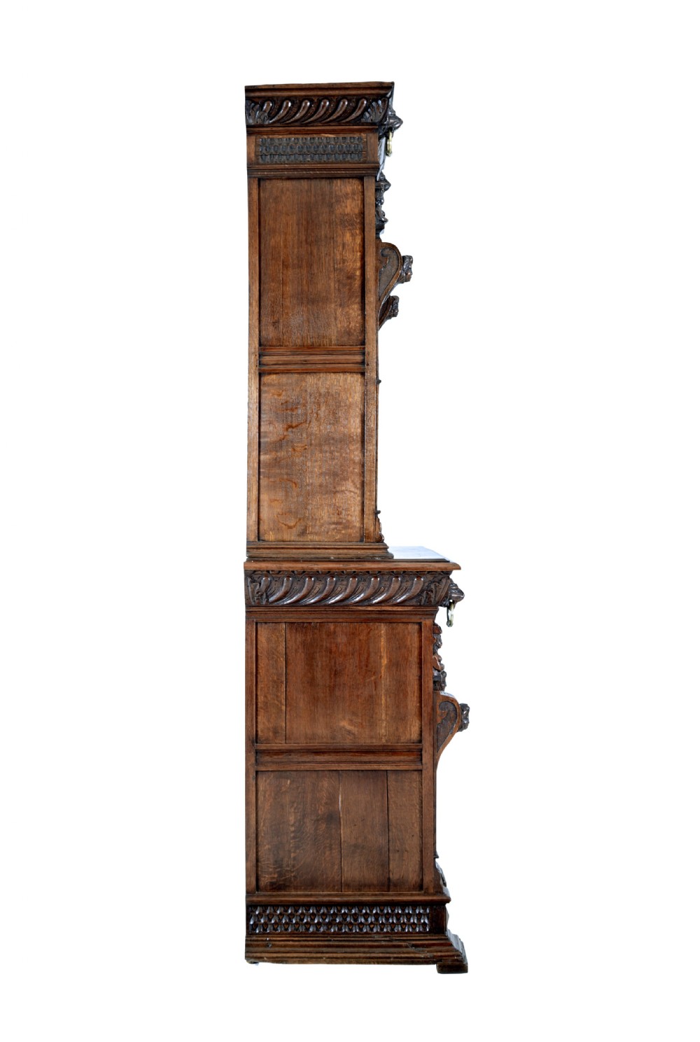 A tall 19th-century Flemish oak cabinet featuring an upper arched leaded glass door and a lower geometric carved wooden door. View VI