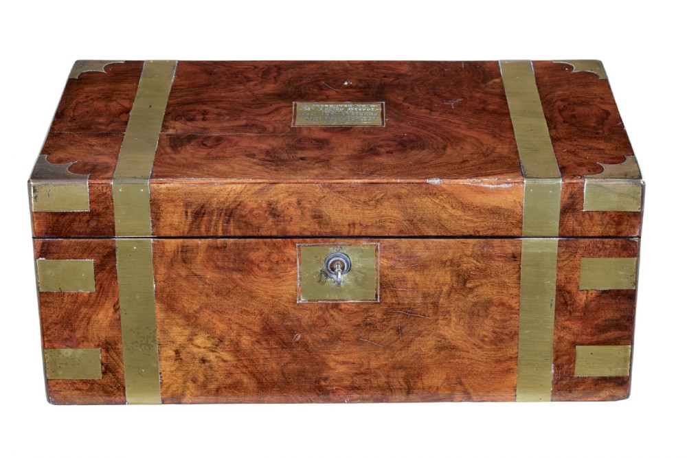 A 19th-century mahogany writing slope featuring polished brass corner mounts, horizontal brass bands, and a central engraved brass plaque.