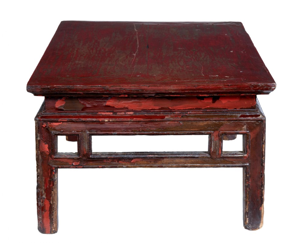 An 18th-century Chinese low table featuring a distressed red lacquer finish, straight square legs, and geometric openwork aprons. View II