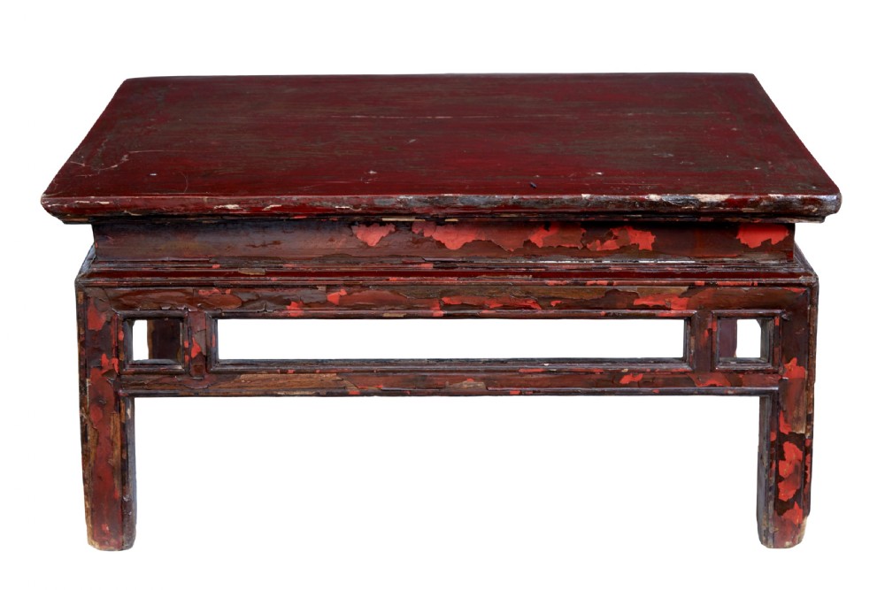 An 18th-century Chinese low table featuring a distressed red lacquer finish, straight square legs, and geometric openwork aprons. View III