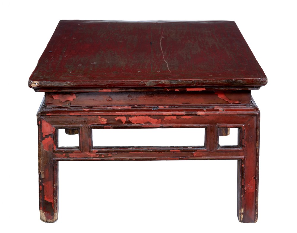 An 18th-century Chinese low table featuring a distressed red lacquer finish, straight square legs, and geometric openwork aprons. View IV