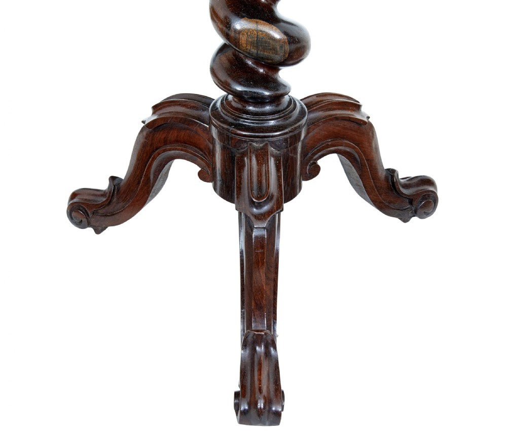 An early Victorian dark walnut tilt top occasional table featuring geometric starburst inlay on a circular top supported by a spiral barley twist pedestal and carved tripod legs. View VII