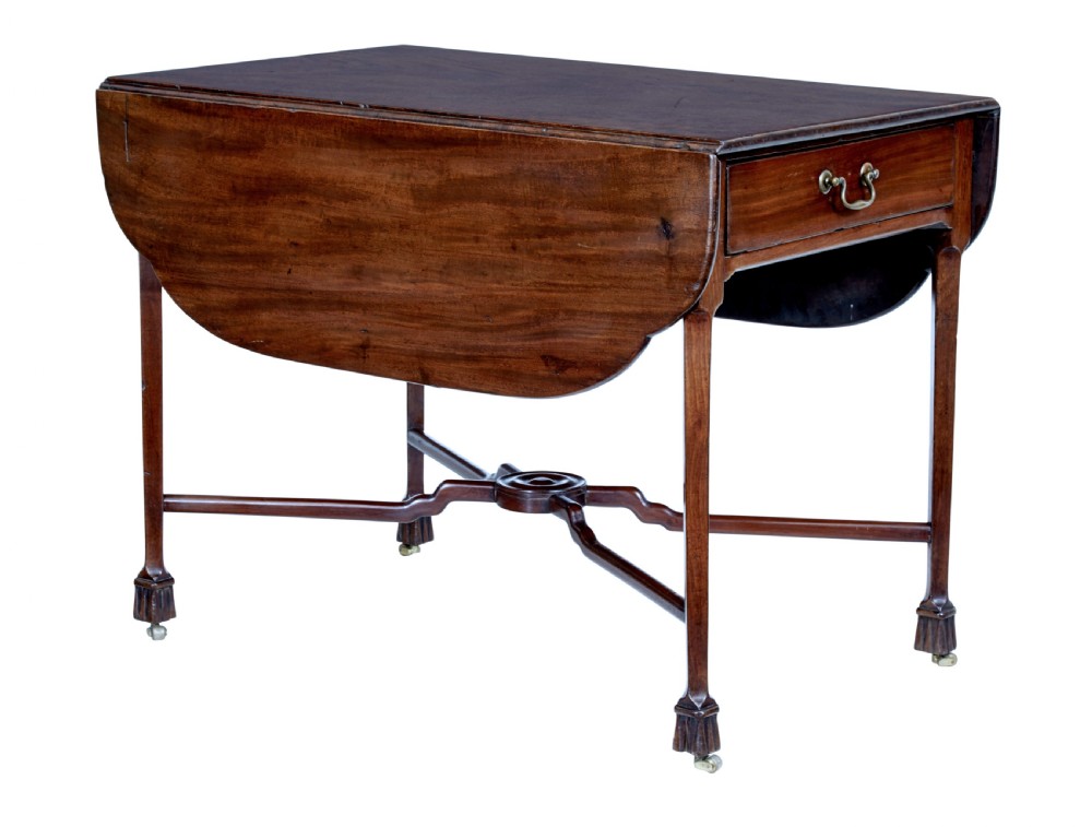 An 18th-century Chippendale mahogany Pembroke table featuring rounded drop leaves, a single end drawer with a brass handle, and an X-frame stretcher.