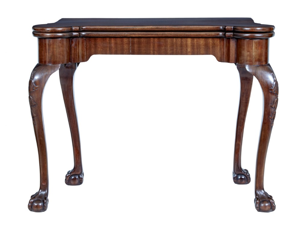 A 19th-century mahogany Chippendale Revival card table featuring a serpentine fold-over top, carved cabriole legs, and ball-and-claw feet.