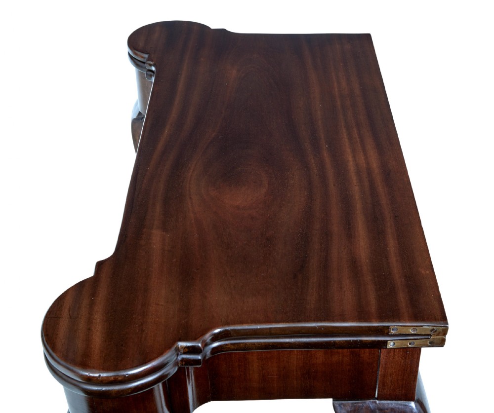 A 19th-century mahogany Chippendale Revival card table featuring a serpentine fold-over top, carved cabriole legs, and ball-and-claw feet. View II