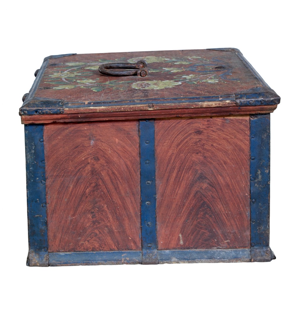 An antique rectangular Swedish wooden box featuring a reddish brown finish with blue painted metal corner straps, a floral lid design, and the painted date 1806. View VI