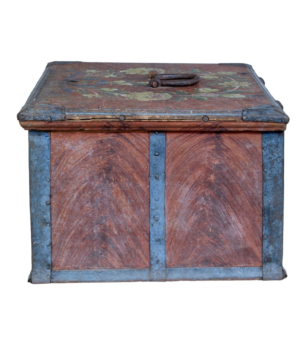 An antique rectangular Swedish wooden box featuring a reddish brown finish with blue painted metal corner straps, a floral lid design, and the painted date 1806. View VII