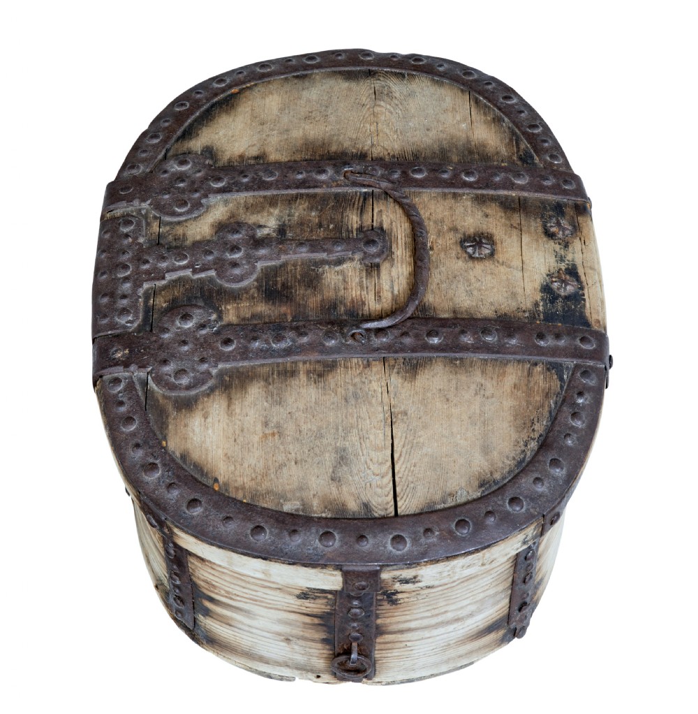 An oval Swedish pine box featuring decorative wrought iron straps, stud detailing, a central keyhole escutcheon, and a top twisted iron handle. View II