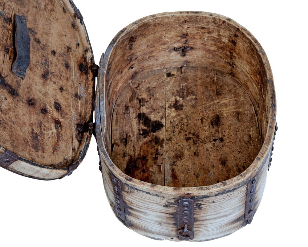 An oval Swedish pine box featuring decorative wrought iron straps, stud detailing, a central keyhole escutcheon, and a top twisted iron handle. View III