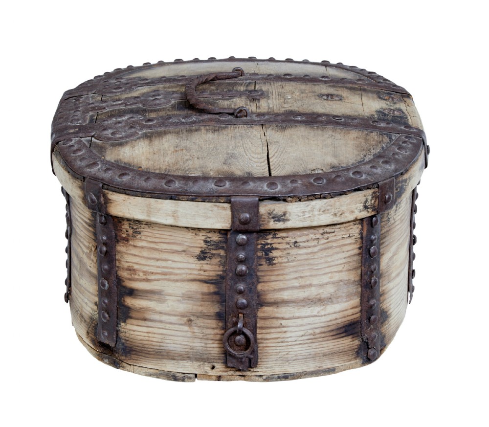 An oval Swedish pine box featuring decorative wrought iron straps, stud detailing, a central keyhole escutcheon, and a top twisted iron handle. View IV