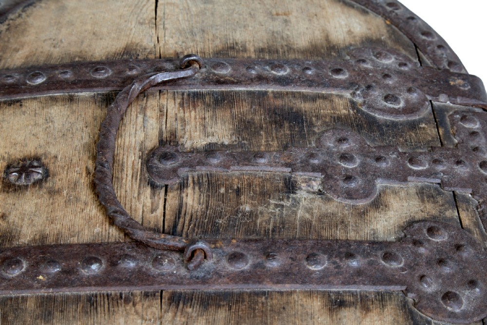 An oval Swedish pine box featuring decorative wrought iron straps, stud detailing, a central keyhole escutcheon, and a top twisted iron handle. View VII