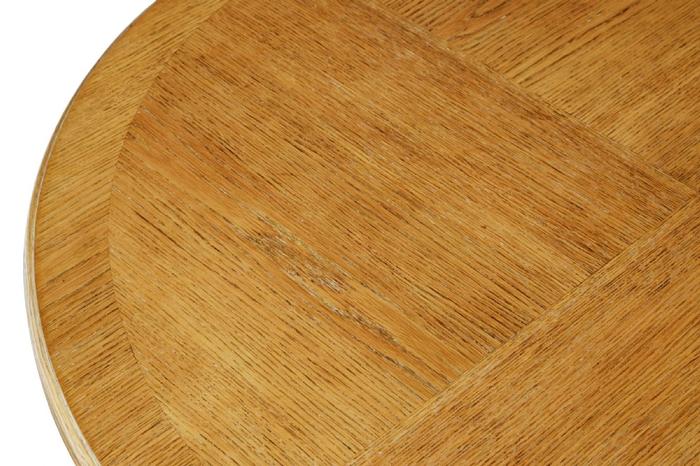 A circular oak occasional table with a parquetry top, carved legs, and paw feet on a white background. View V