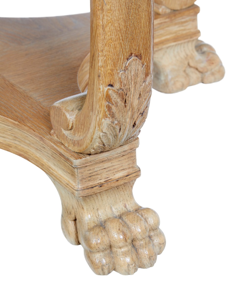 A circular oak occasional table with a parquetry top, carved legs, and paw feet on a white background. View VI