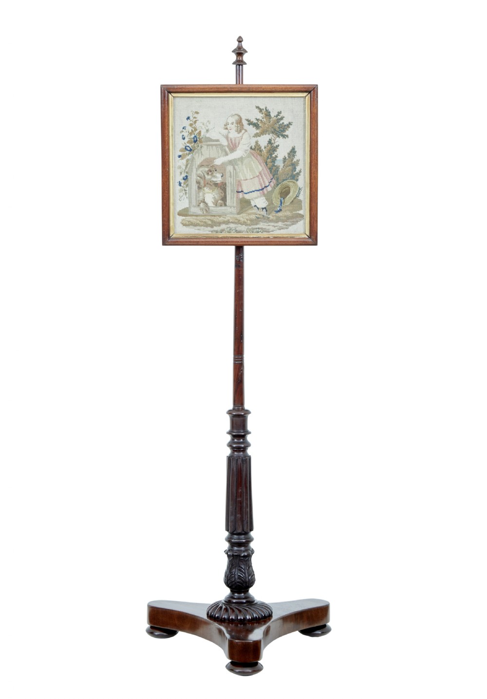 A nineteenth-century William IV mahogany pole screen featuring an adjustable square needlepoint panel depicting a child and dog, supported by a turned column and triform base.