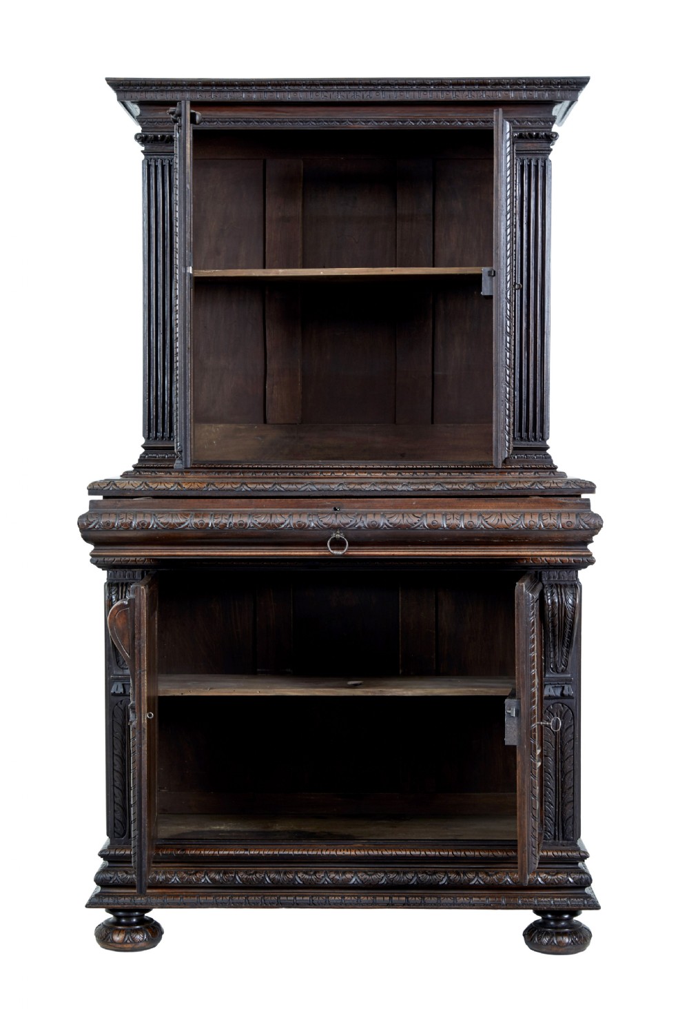 A two-section mid-19th century dark walnut cabinet featuring detailed relief carvings on the panelled doors, fluted columns, and flattened bun feet. View II
