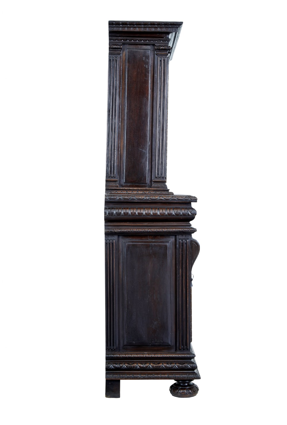 A two-section mid-19th century dark walnut cabinet featuring detailed relief carvings on the panelled doors, fluted columns, and flattened bun feet. View V