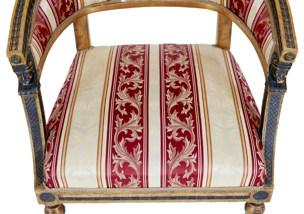 A pair of 19th-century Swedish giltwood armchairs featuring curved backs, black carved terminals with female heads, and red and cream striped fabric upholstery. View VIII