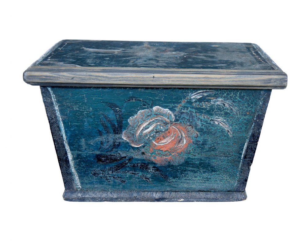 A small 19th-century wooden sarcophagus box featuring distressed blue paint, white hand-painted decorative flourishes, and a central diamond-shaped iron keyhole escutcheon. View III