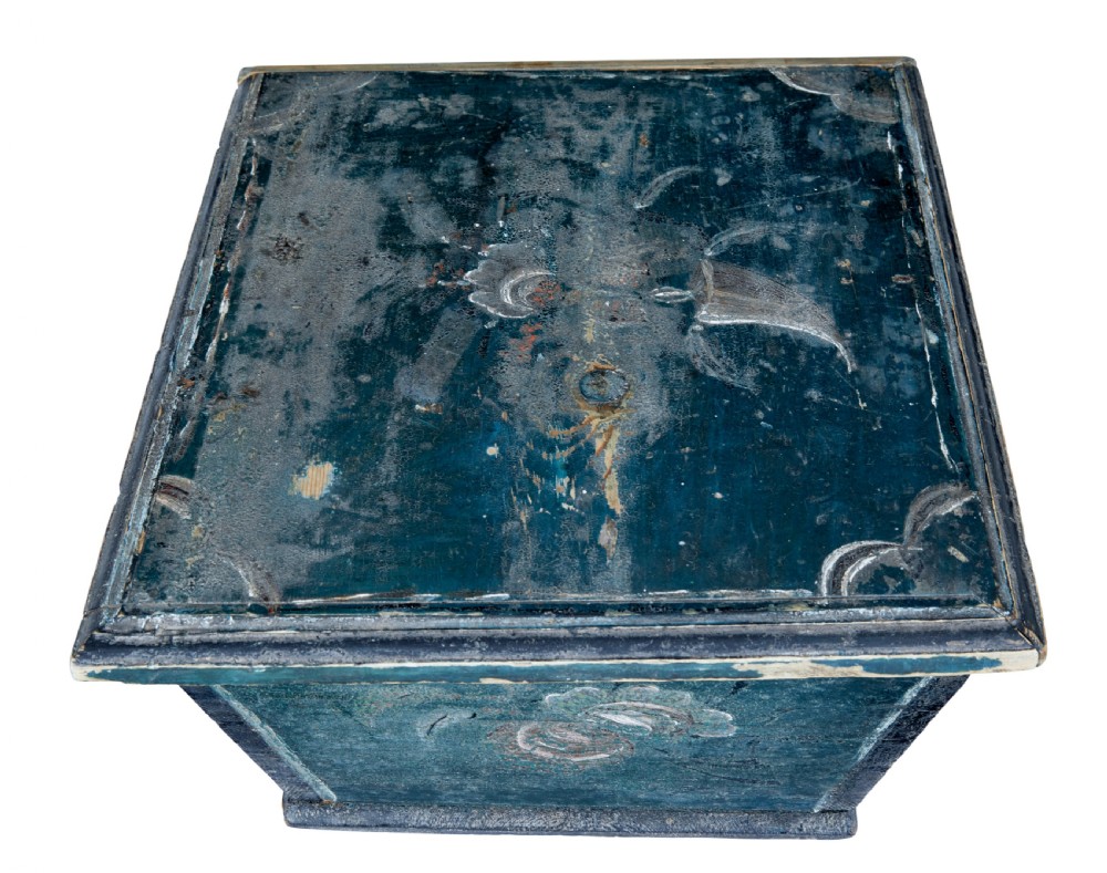 A small 19th-century wooden sarcophagus box featuring distressed blue paint, white hand-painted decorative flourishes, and a central diamond-shaped iron keyhole escutcheon. View VI