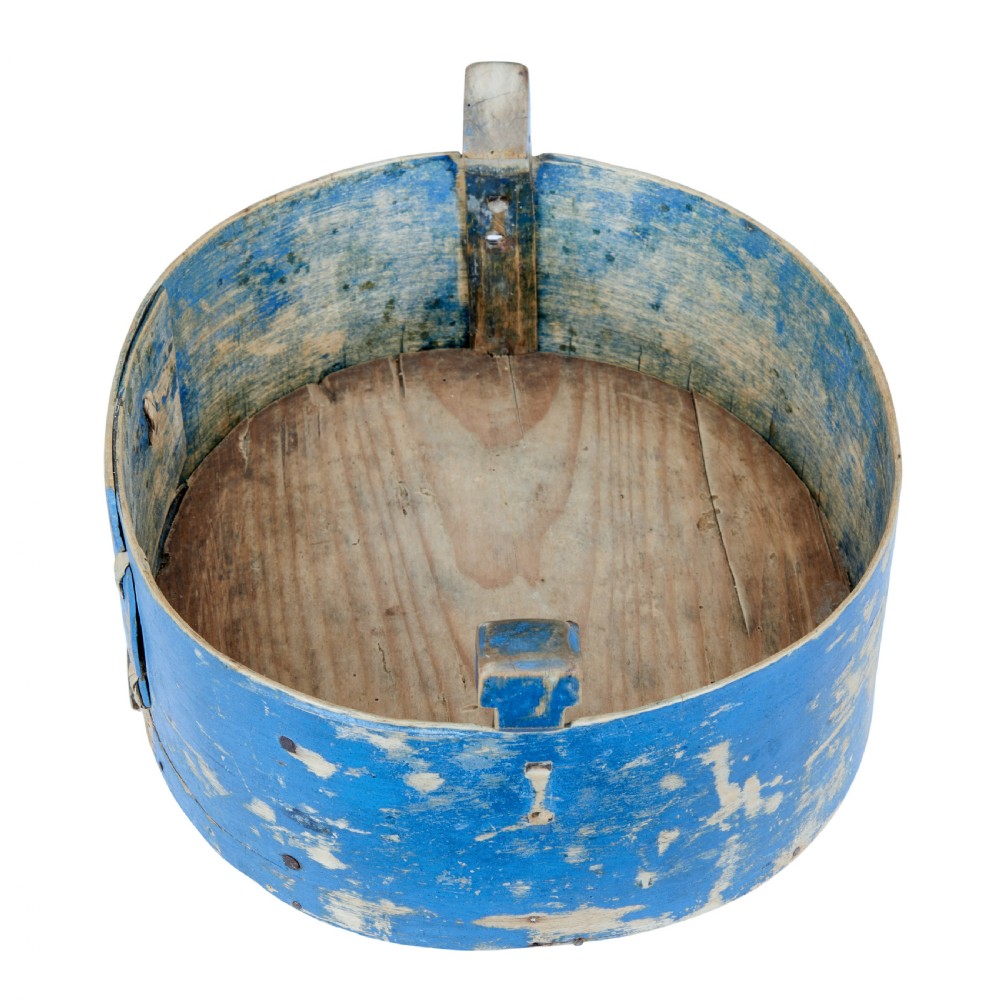 A 19th-century oval wooden tine box featuring distressed blue paint, vertical end pegs, a bentwood top handle, and root lacing. View III