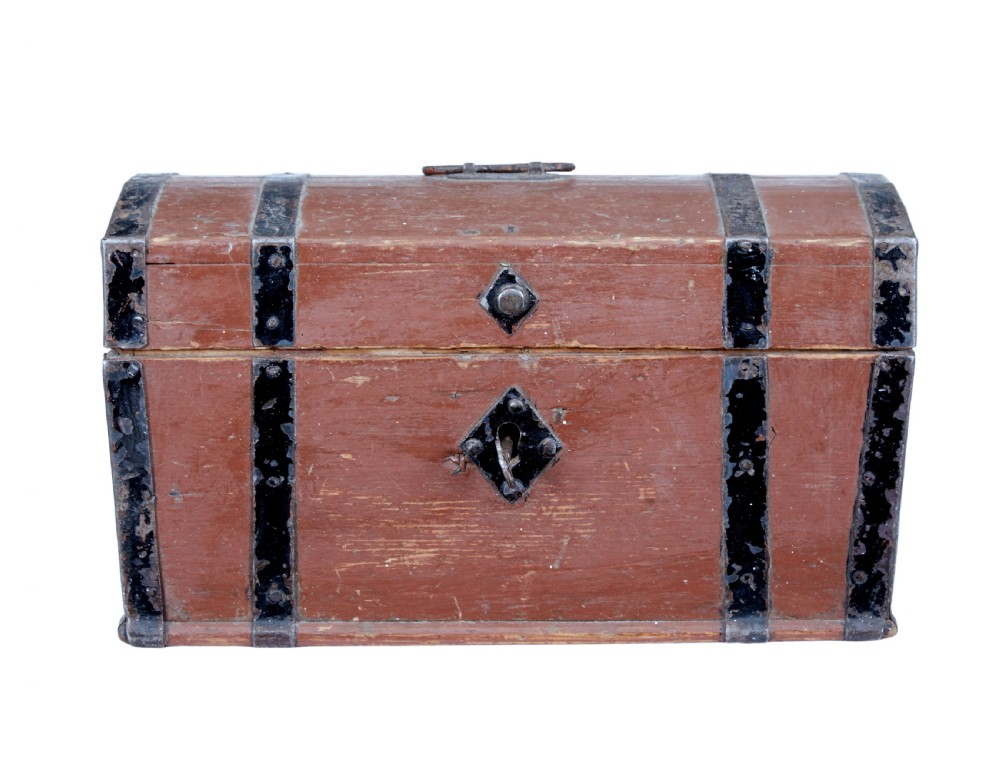 A nineteenth-century Scandinavian pine box featuring a domed lid, terracotta red painted finish, black iron straps, and a central diamond escutcheon with key. View II