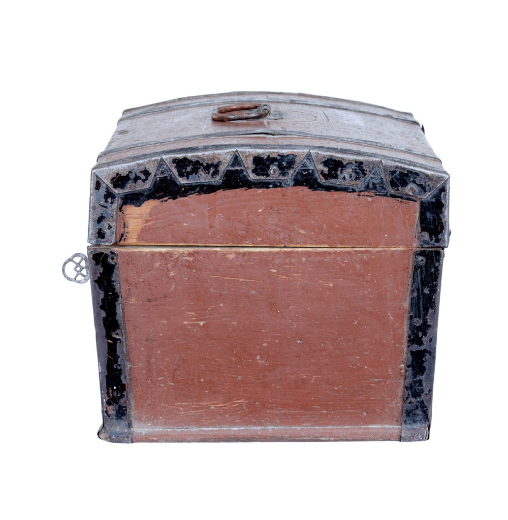 A nineteenth-century Scandinavian pine box featuring a domed lid, terracotta red painted finish, black iron straps, and a central diamond escutcheon with key. View III
