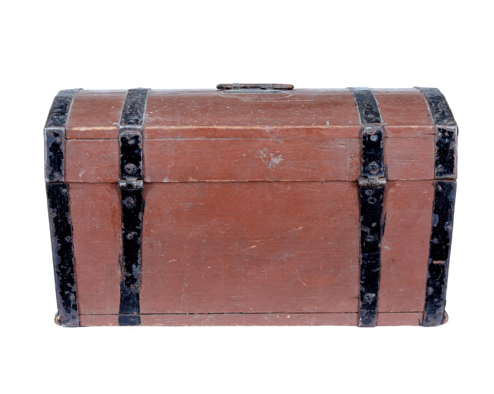 A nineteenth-century Scandinavian pine box featuring a domed lid, terracotta red painted finish, black iron straps, and a central diamond escutcheon with key. View IV
