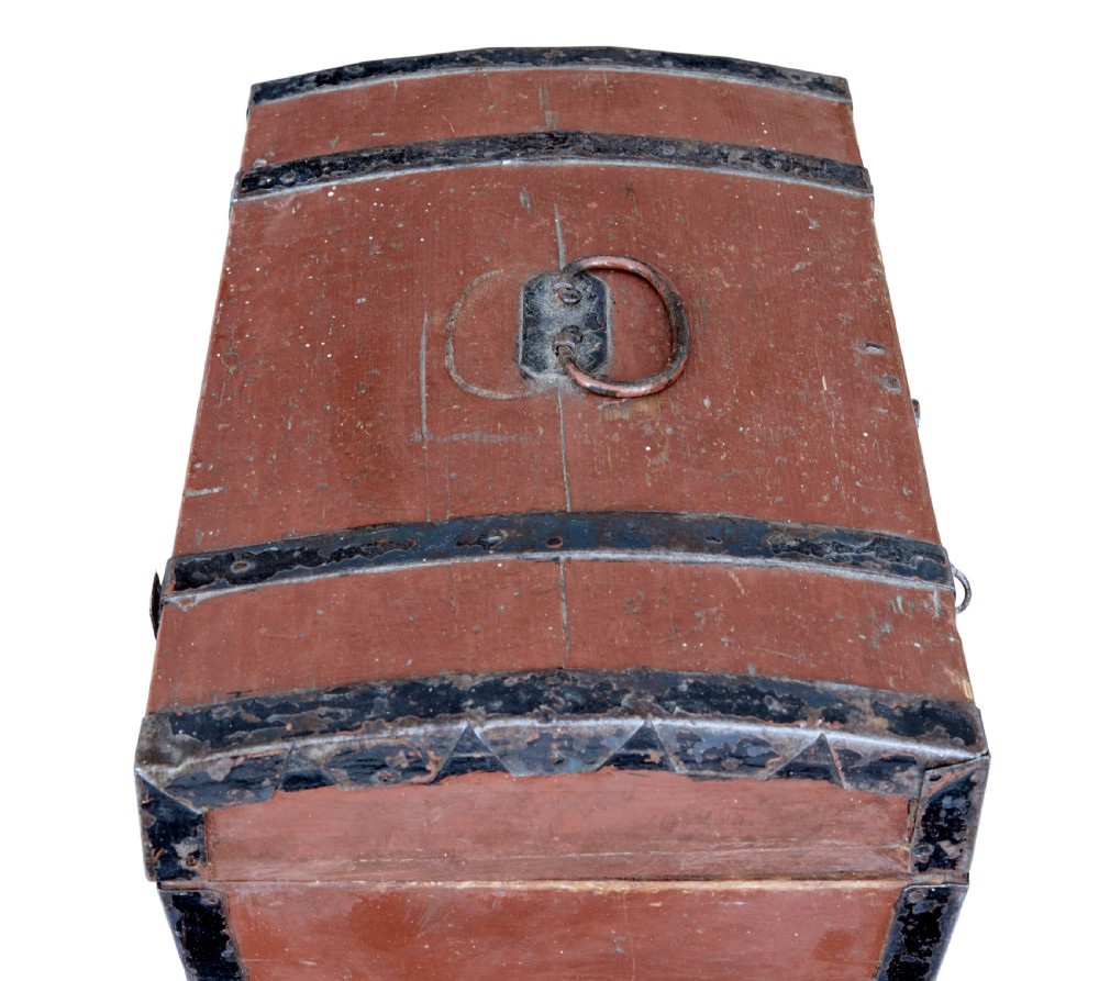 A nineteenth-century Scandinavian pine box featuring a domed lid, terracotta red painted finish, black iron straps, and a central diamond escutcheon with key. View VI