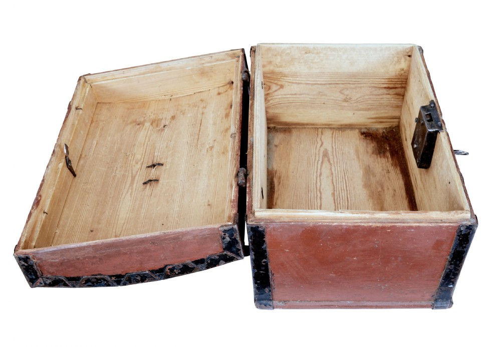 A nineteenth-century Scandinavian pine box featuring a domed lid, terracotta red painted finish, black iron straps, and a central diamond escutcheon with key. View VII