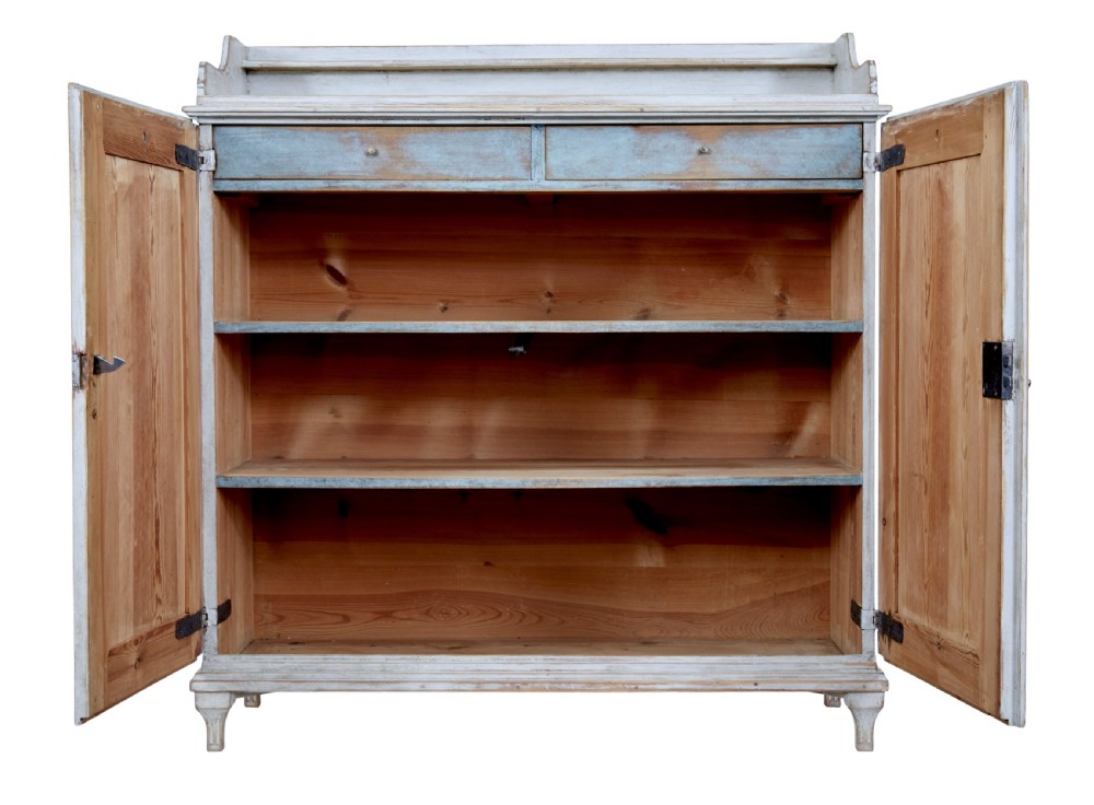A 19th-century Swedish pine cupboard featuring distressed off-white painted finishes, double doors carved with diamond motifs, tapered short legs, and a low gallery top. View III