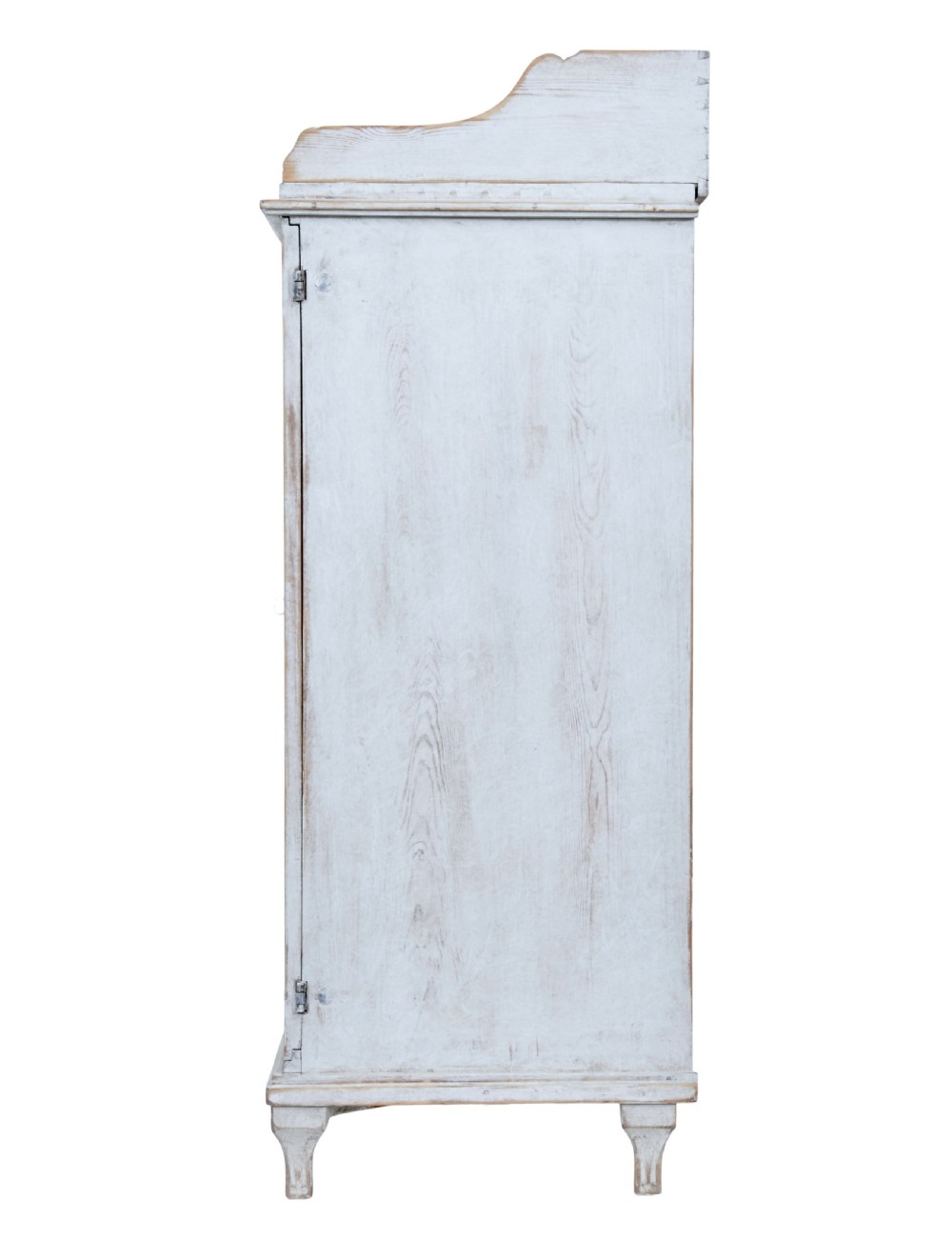 A 19th-century Swedish pine cupboard featuring distressed off-white painted finishes, double doors carved with diamond motifs, tapered short legs, and a low gallery top. View IV