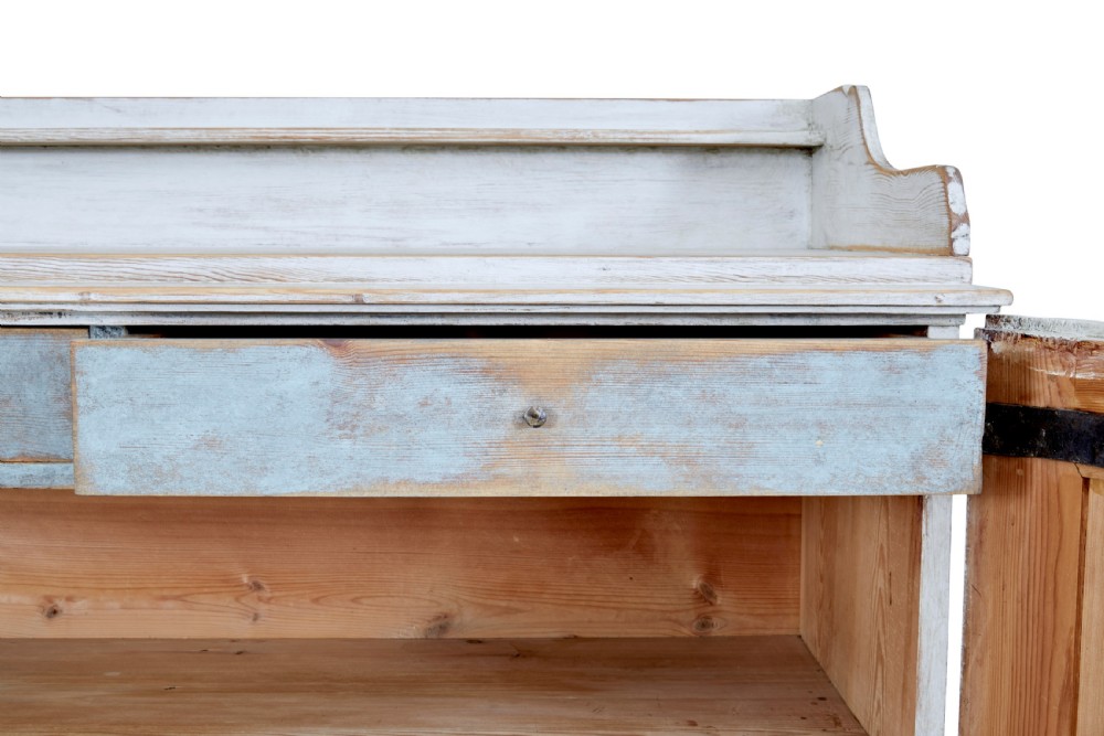A 19th-century Swedish pine cupboard featuring distressed off-white painted finishes, double doors carved with diamond motifs, tapered short legs, and a low gallery top. View VIII