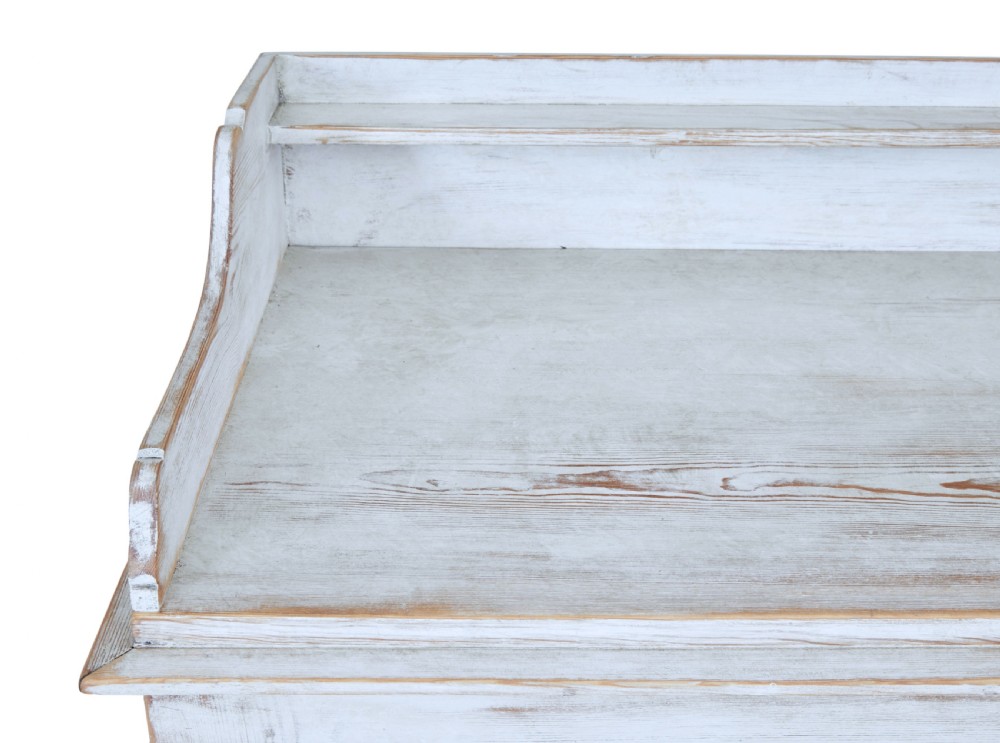 A 19th-century Swedish pine cupboard featuring distressed off-white painted finishes, double doors carved with diamond motifs, tapered short legs, and a low gallery top. View IX